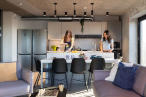 Residents squeezing lemons in communal Kitchen in Basestack Bryggen student accommodation and apartments to rent in Copenhagen