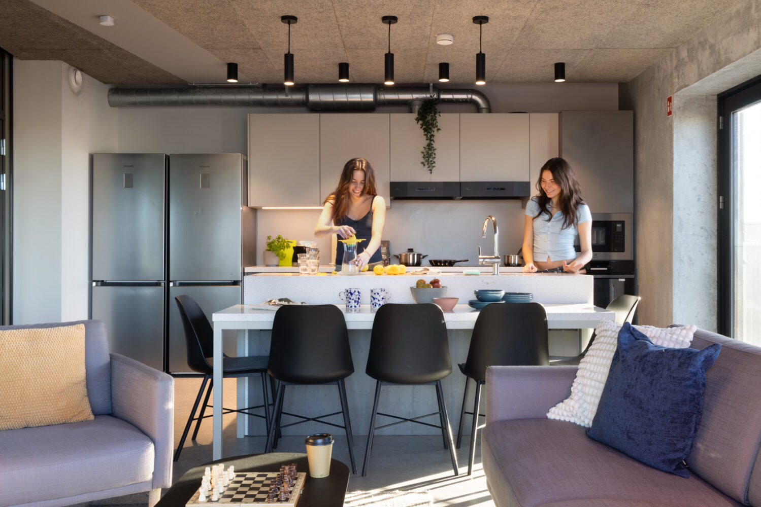 Residents squeezing lemons in communal Kitchen in Basestack Bryggen student accommodation and apartments to rent in Copenhagen
