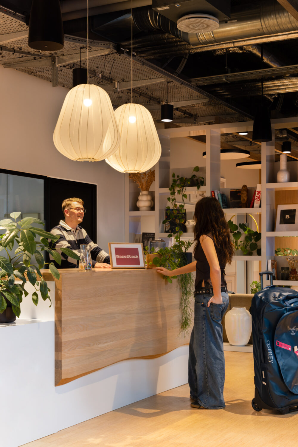 Manager at Basestack Living checking in a new resident at the front desk in Basestack Living student and co-living apartments in Copenhagen