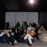 A number of student residents enjoying a film in the cinema room of Tribera student apartments