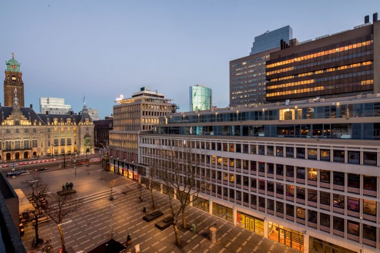 Evening view of Stadhuisplein in Rotterdam with th Hermes City Plaza building on the right.
