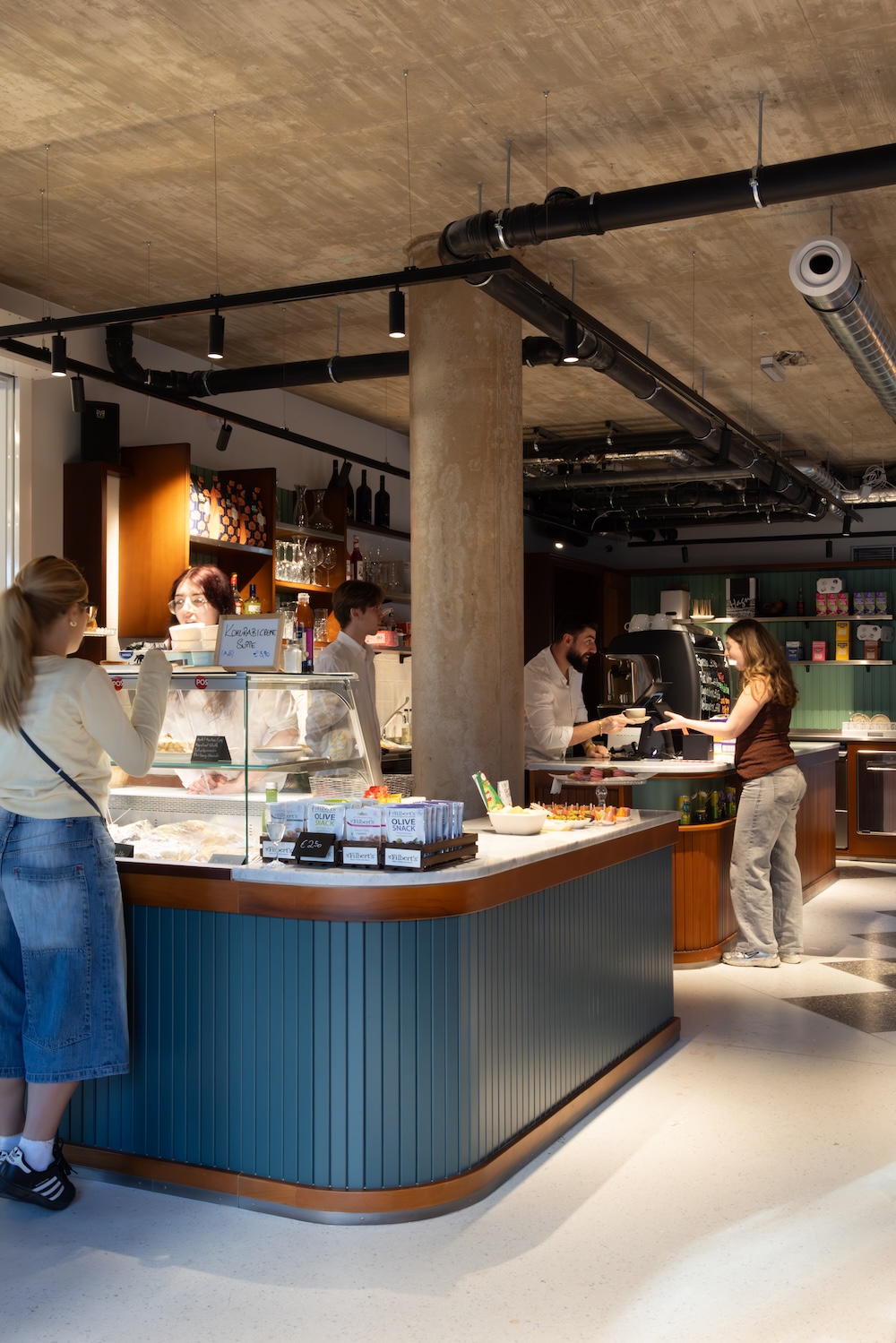 Students walking between social kitchen tables at student accommodation
